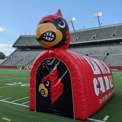 An inflatable red and black cardinal-themed tunnel with a large cardinal bird head on top.